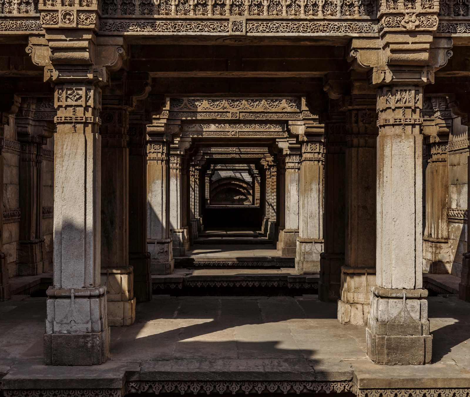 Ancient intricately carved stone corridor in India.