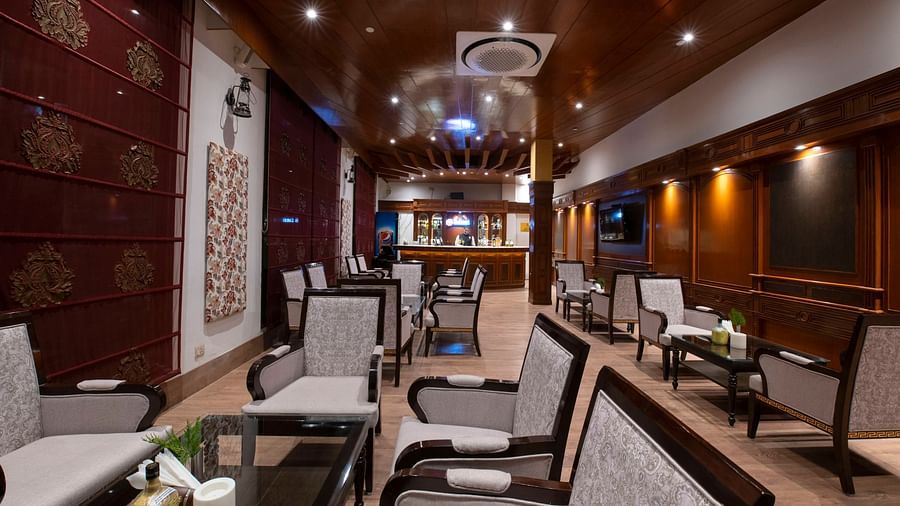 an image of a spacious bar with multiple chairs and tables