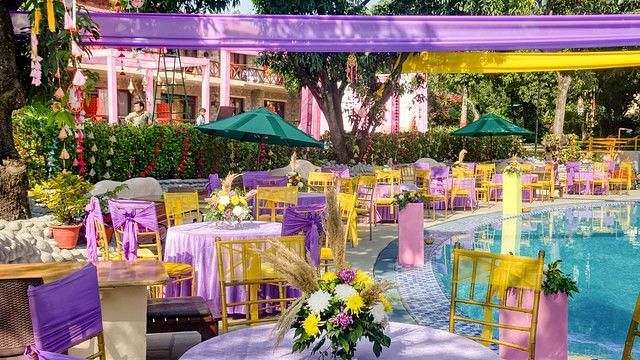 alt-text Outdoor wedding reception with tables and chairs.