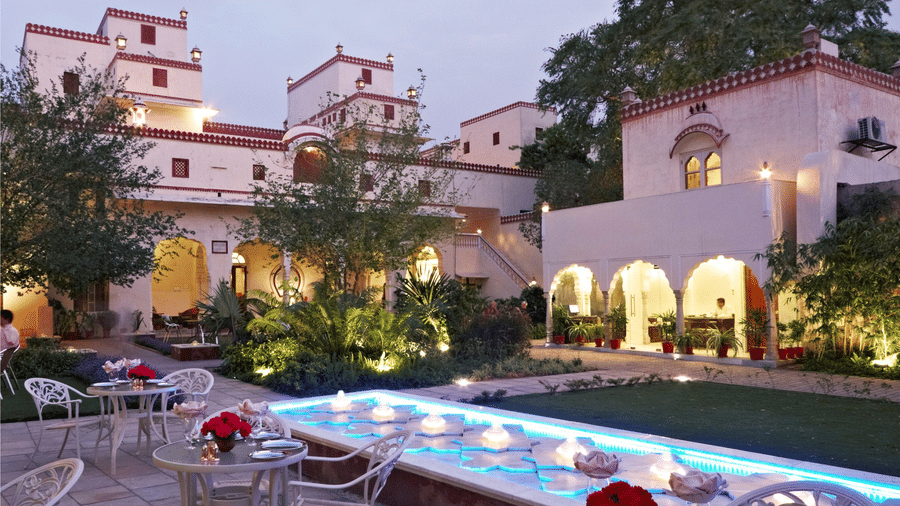 Seating arrangements in the courtyard next to the fountain at anada restaurant at Mandawa Haveli, Jaipur