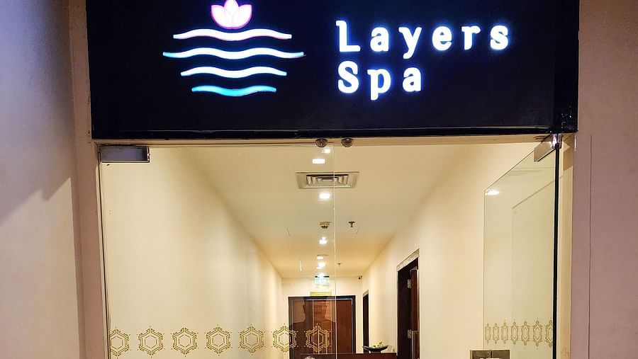 Layers Spa- Entrance Glass Door with Warm white lighting inside and Name on the above