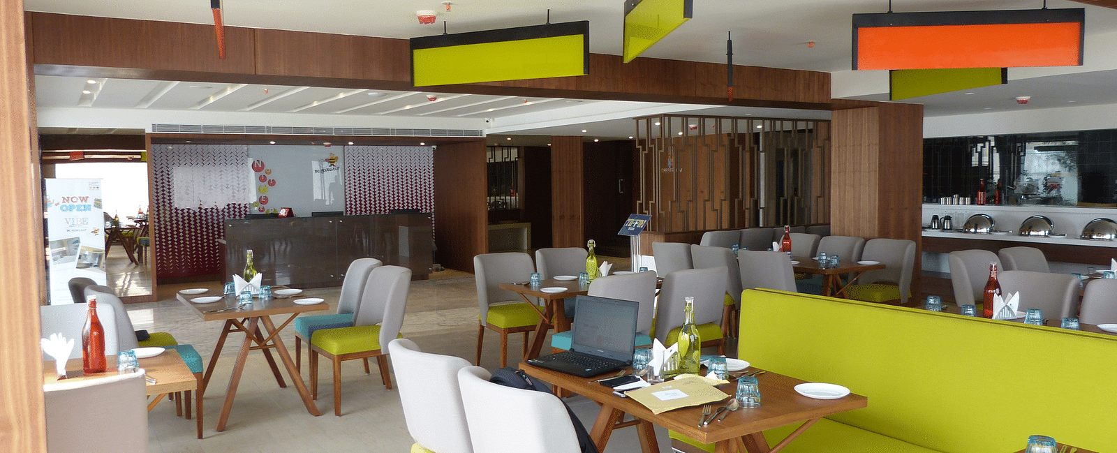The dining area is set up with tables and chairs arranged neatly for the guests