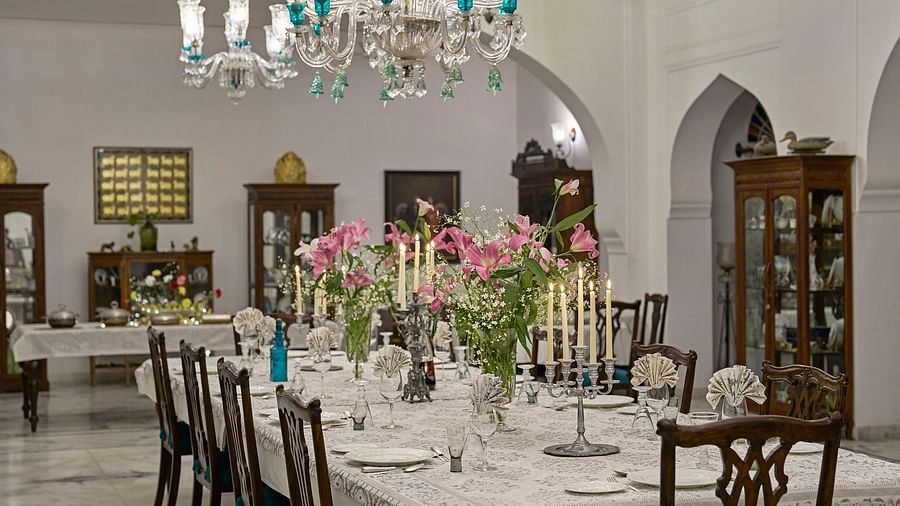 image highlighting the long dining table decorated with flowers and candles at dev shree, deogahr