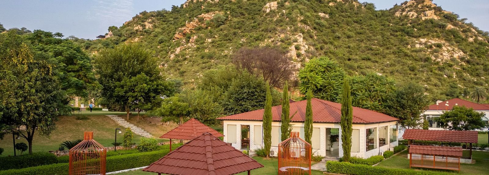 Top view of an open-air dining space at Valley by Grassfield, set against a stunning mountain backdrop.