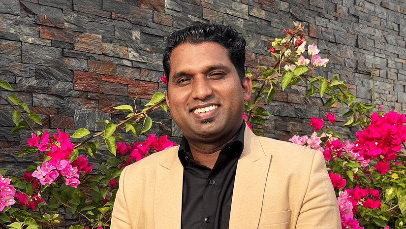 A potrait image of a  person posing for a picture with the flower background