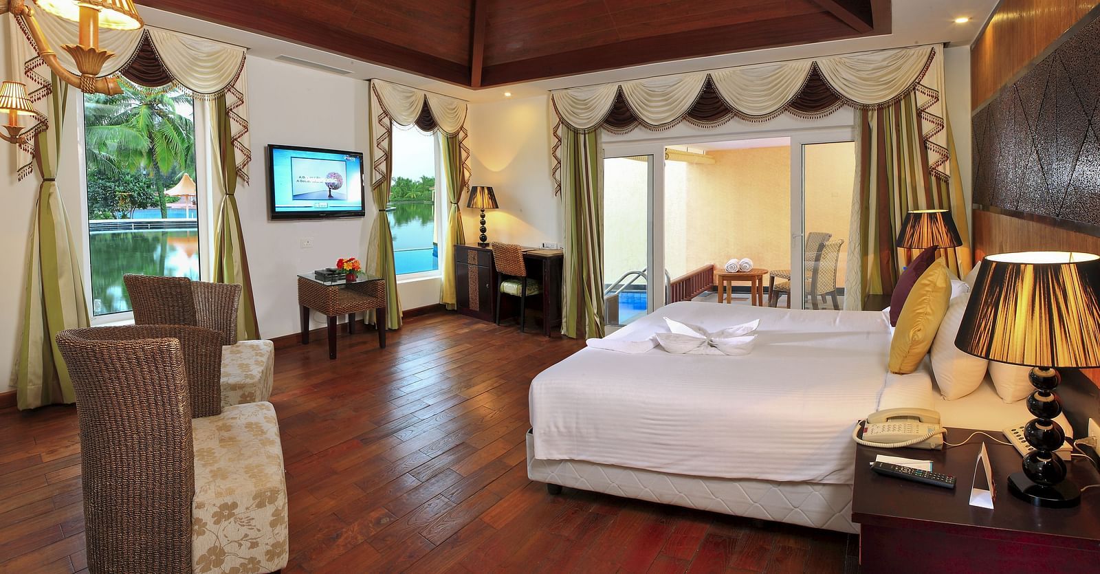 Bedroom with a bed and floor-to- ceiling window at Ocean Spray Puducherry