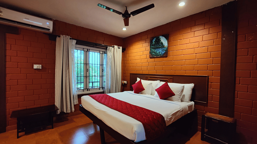 A double bed inside Executive Deluxe Room View at Ibex River Resort, Pollachi.