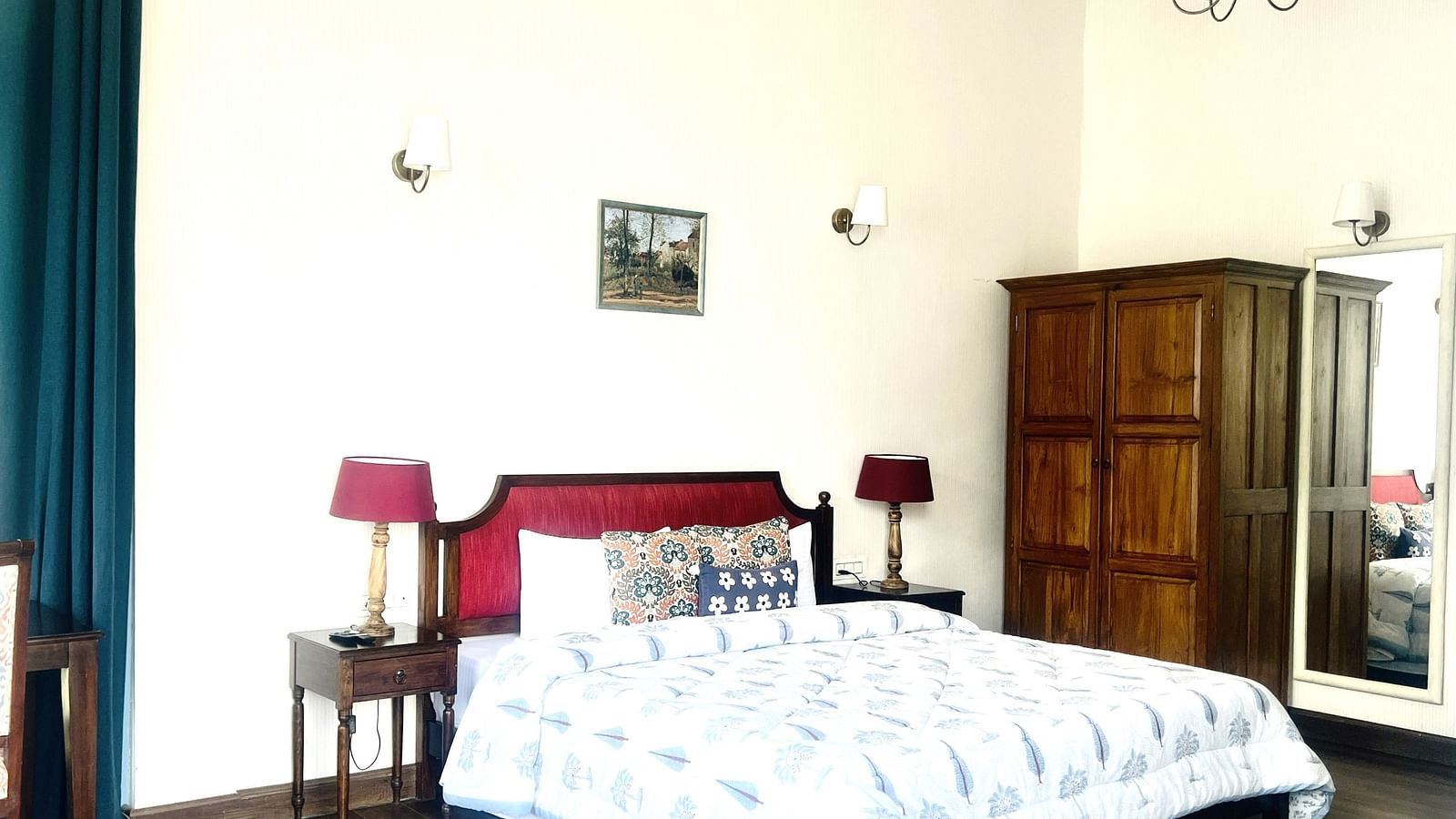 Classic hotel bedroom with white walls, a large red headboard, and a vintage wooden wardrobe in a spacious room.Classic hotel bedroom with white walls, a large red headboard, and a vintage wooden wardrobe in a spacious room  | Faraway Cottages, Auli