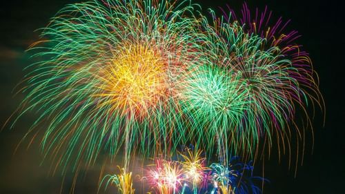 Fireworks light up the night sky, creating a vibrant display against the darkness.