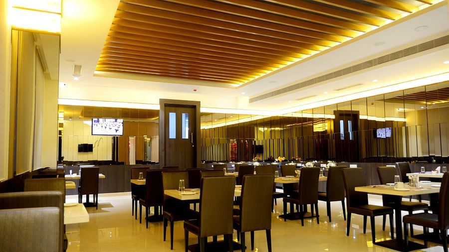 dining of a restaurant with warm lights of ASR Parklane, Hosur