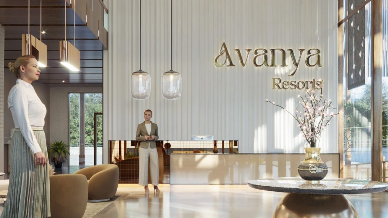A hotel reception desk displaying the 'Avanya' logo on the wall with a modern, sleek design - Avanya Resorts Private Limited, Chennai
