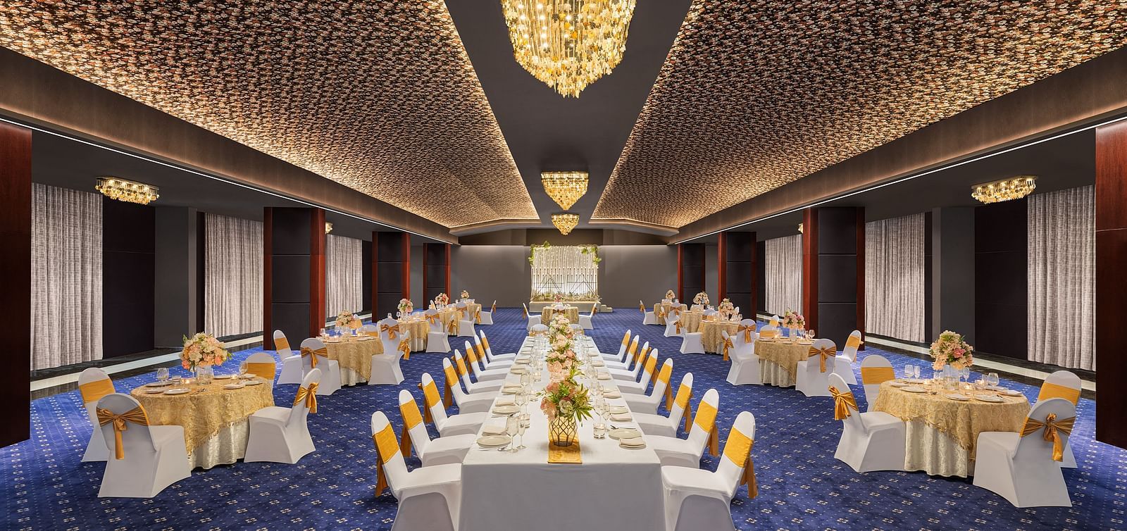  Image of a hall with table and chiar arrangement and lights on the ceiling at Essentia Luxury Hotel, Indore