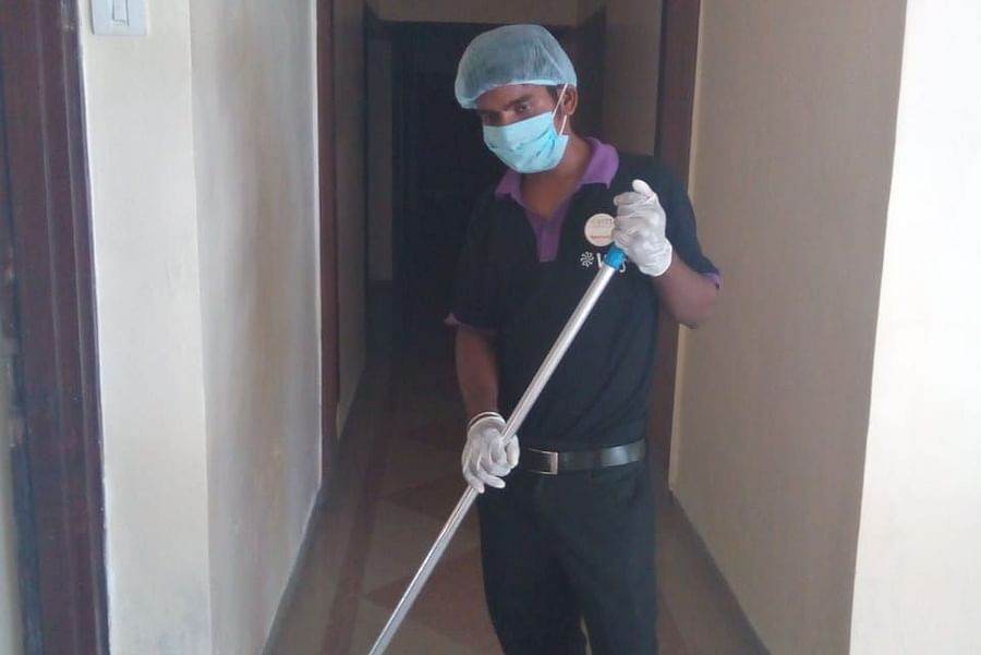 a staff member cleaning the corridor at one of the hotels - VITS Hotels & Resorts