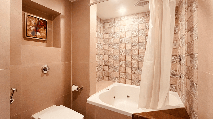 A bathroom of the Premier Smart Suite featuring a Jacuzzi tub alongside a commode at the Senses Hotel.