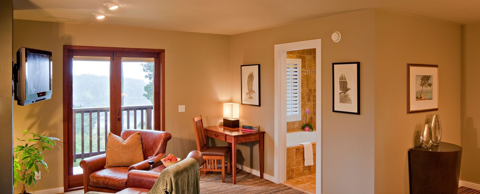 A cosy room in Mendocino with warm lighting, plush seating, and scenic views - Brewery Gulch Inn & Spa