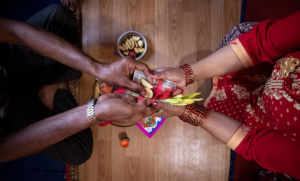 Dashain Festival top view of man and women holding hands for a ritual