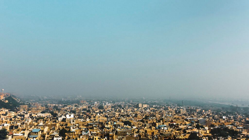 A aerial shot of a city with a clear blue sky in the background