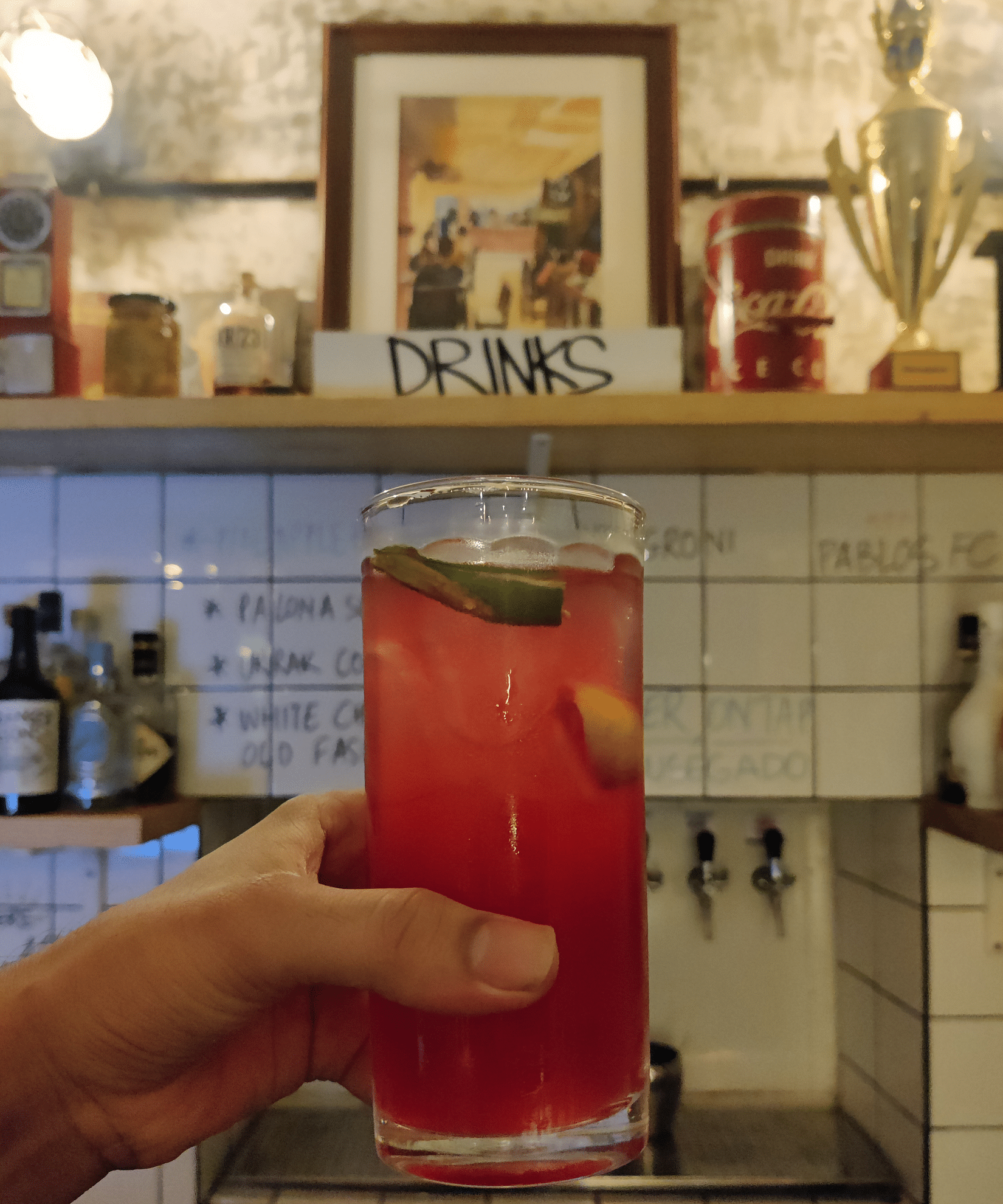 A person holds a drink - Villa in Palms by V Escapes