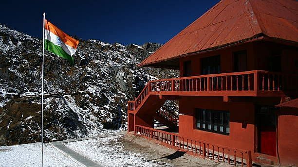 Image of India Sikkim border with an red builing in it and indian flag