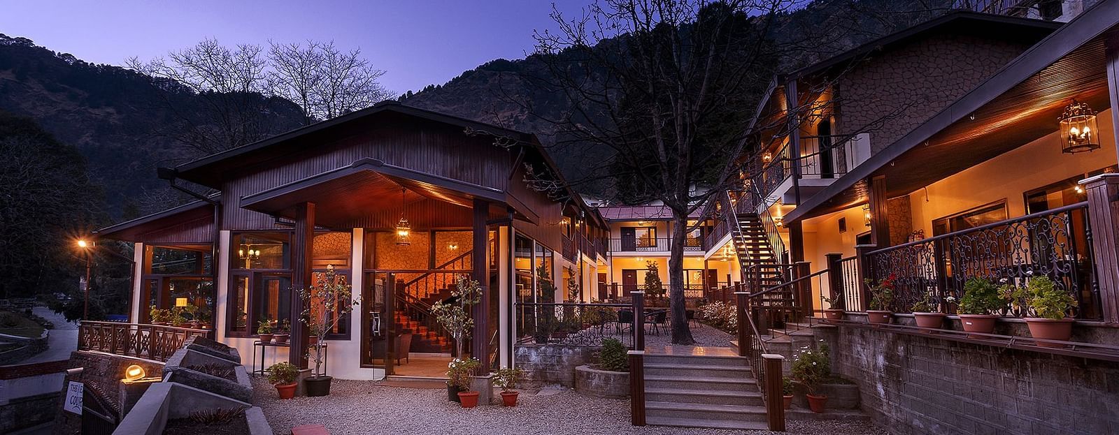 The Earl's Court Nainital - Leisure Hotels with sunset hues in the background.