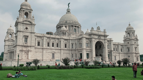 An overview of Victoria Memorial with a manicured garden in front of it in the New Market area