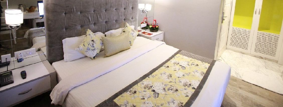 Elegant room with a large bed and a bed side table