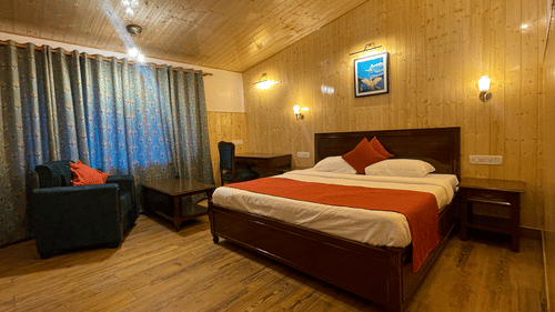 Spacious lake Facing Cottage room with a cosy bed at Himalaya Hotel, Nainital