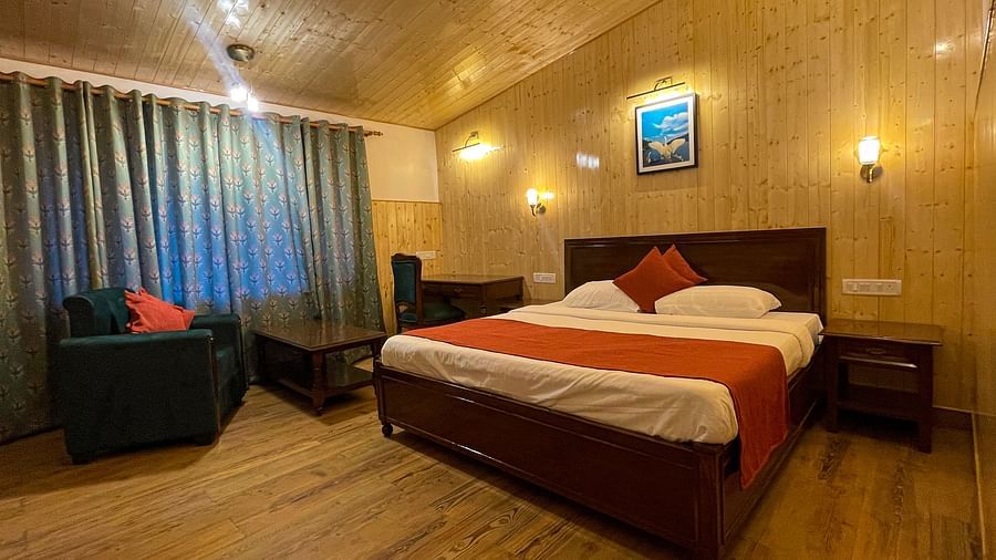 Spacious lake Facing Cottage room with a cosy bed at Himalaya Hotel, Nainital