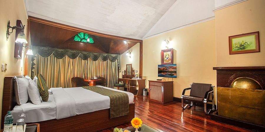 Heritage Club King Room at Central Heritage Resort & Spa, The Mall, Darjeeling - a spacious and elegant accommodation with classic decor and wooden flooring.