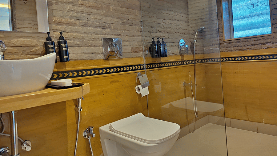 Bathroom with a washbasin, toilet, mirror, and tiled walls