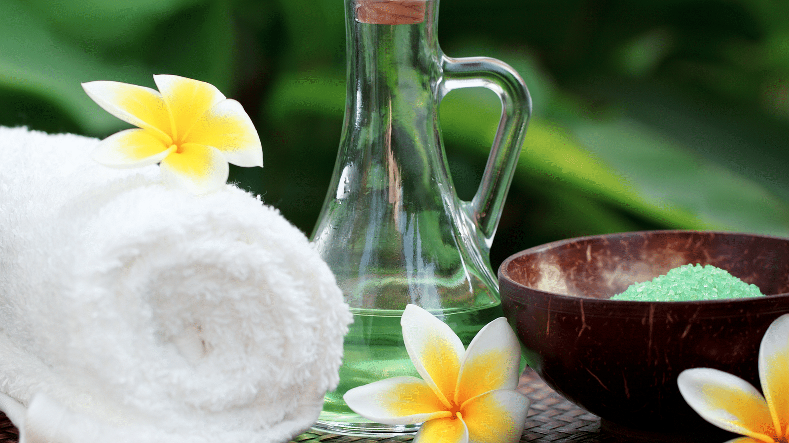 an image of  rolled up towel and a glass jar symbolises wellness - Rhythm Lonavala