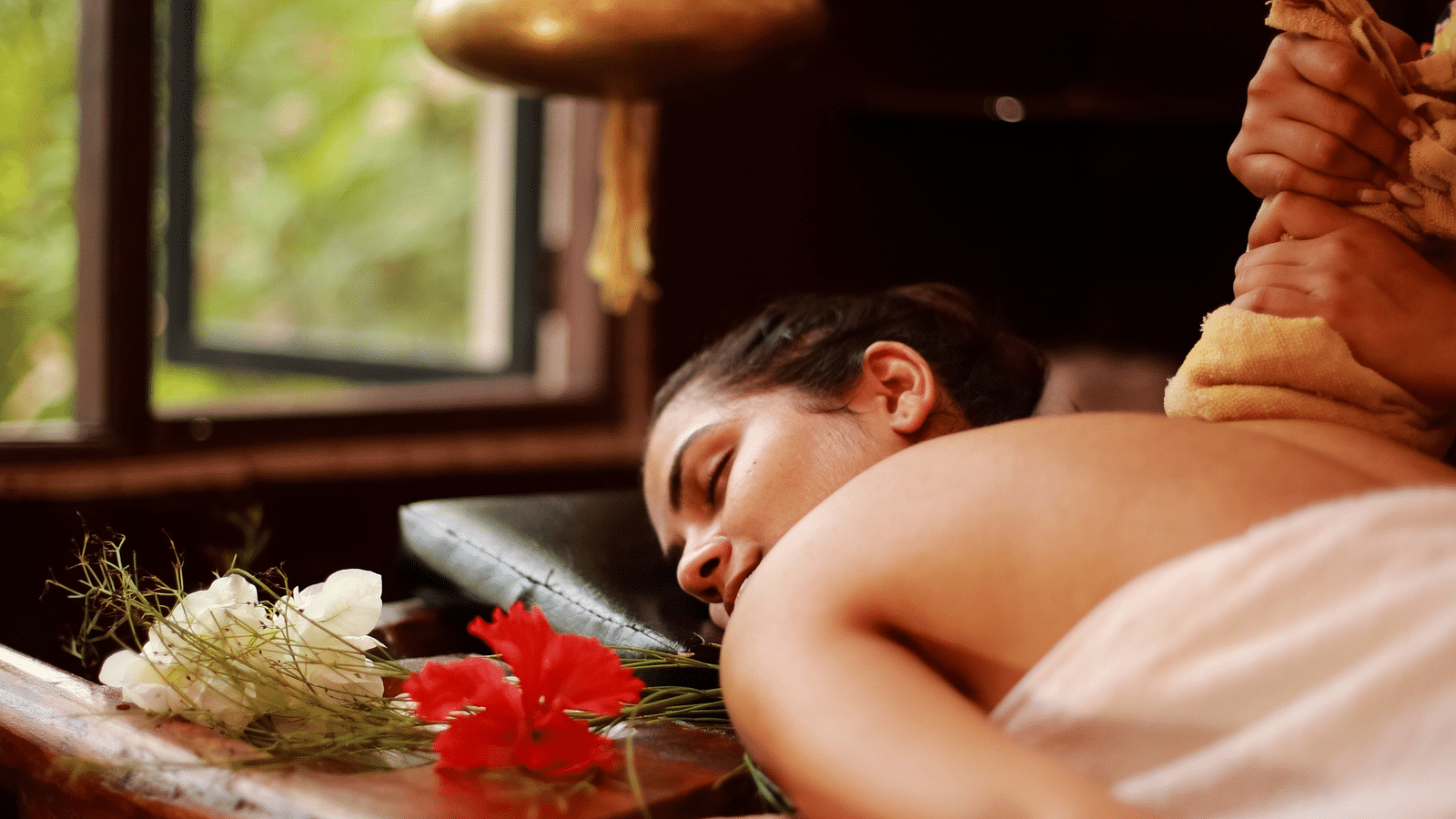 an image of a woman attending a spa therapy - best resort in Lonavala for group - Rhythm Lonavala