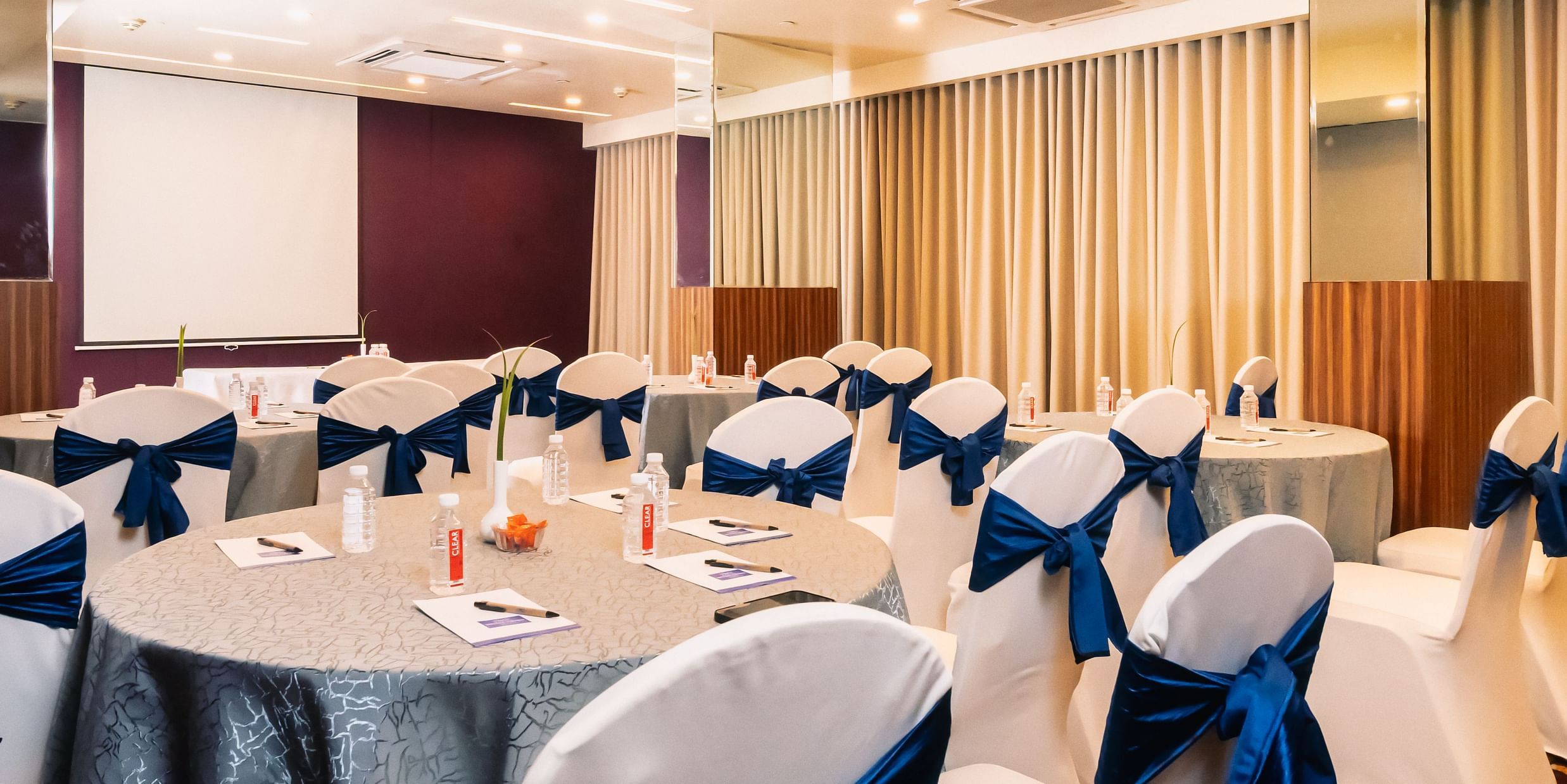 Banquet hall with well arranged chair and table at Marasa Sarovar Portico, Rajkot