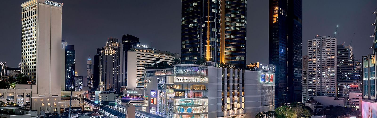 a wide angled view of Asok Montri Road at night