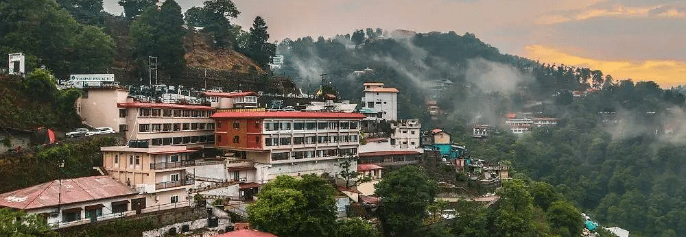 a beautiful landscape of the city of rishikesh with a mesmerising sunset in the background with orange and grey hues