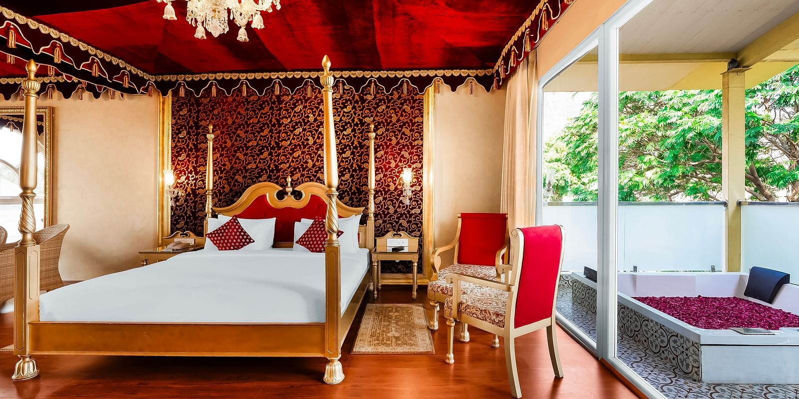 An overview of a room with a double bed, chairs and a bathtub outside - Rajasthali Resort & Spa, Jaipur.