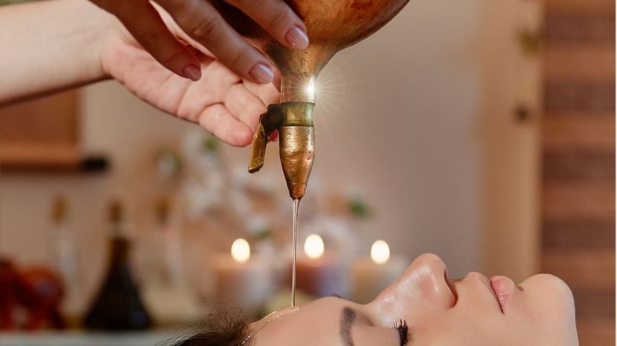 an image of a woman undergoing oil therapy - Rhythm Lonavala