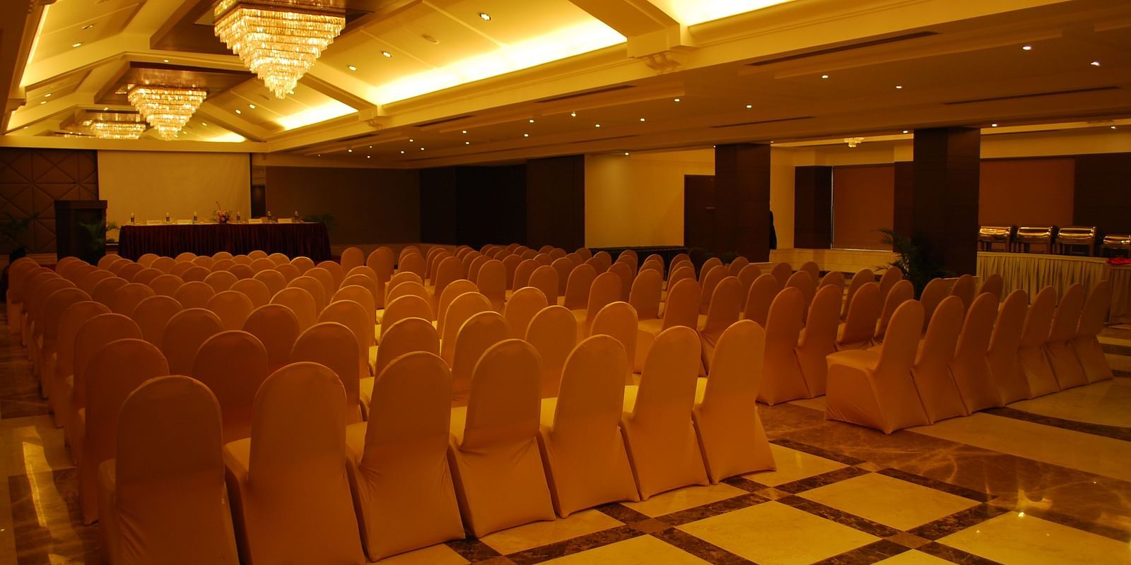 Banquet Hall with warm lighting and chairs arranged for celebrations
