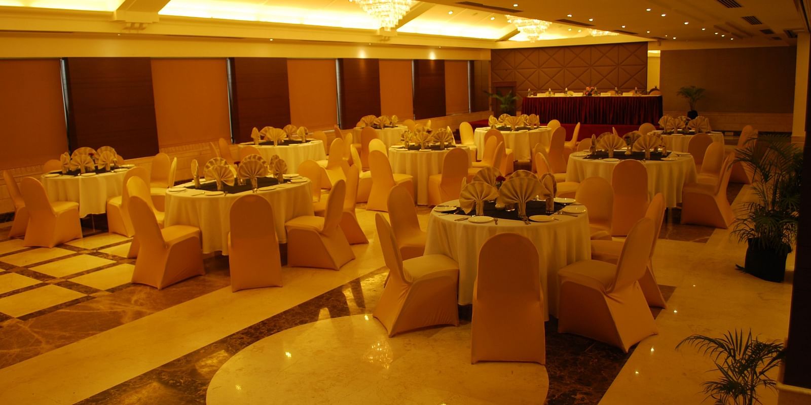 Banquet Hall with round tables and chairs arranged neatly around them