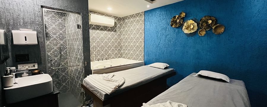 Spa treatment room at Nemesia with a massage table and modern decor.