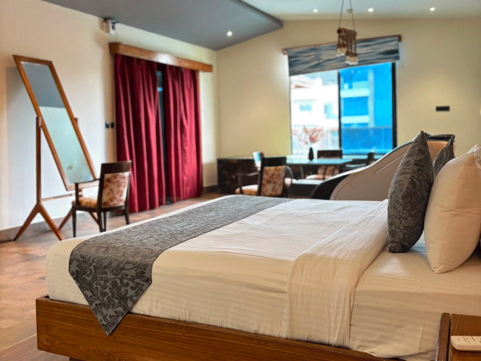 Skyline by Miraya, Emperor Suite, King bed with dresser mirror and window seating