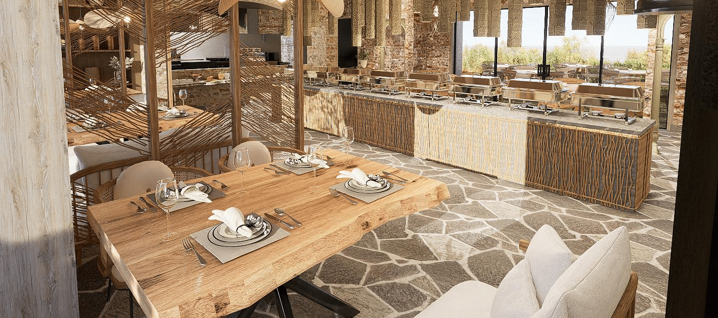Diagonal view of the restaurant with neatly set tables and chairs, featuring a central table with a buffet setup at The Evren, Vagator.