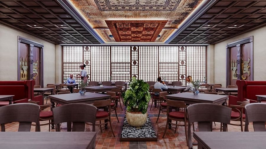 Dining area with chairs and tables, featuring a patterned ceiling at The Orchid Hotel, Chandigarh.