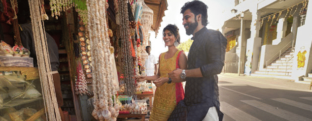 a man and a woman buying accessories in a shop