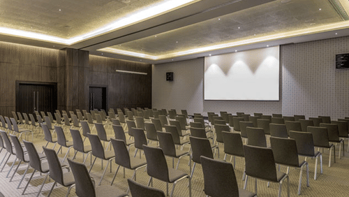 rows of chair facing a screen at The Residency Towers Rameswaram