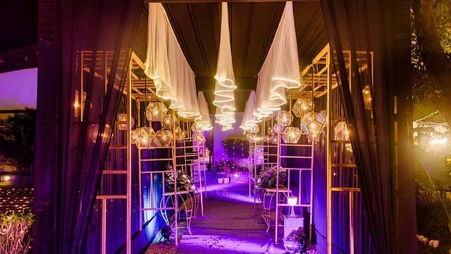 alt-text Outdoor dining area with string lights and lanterns.