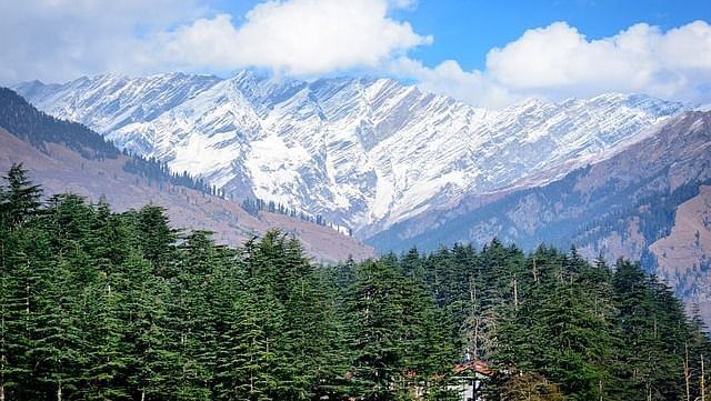 A scenic view of snow covered mountains
