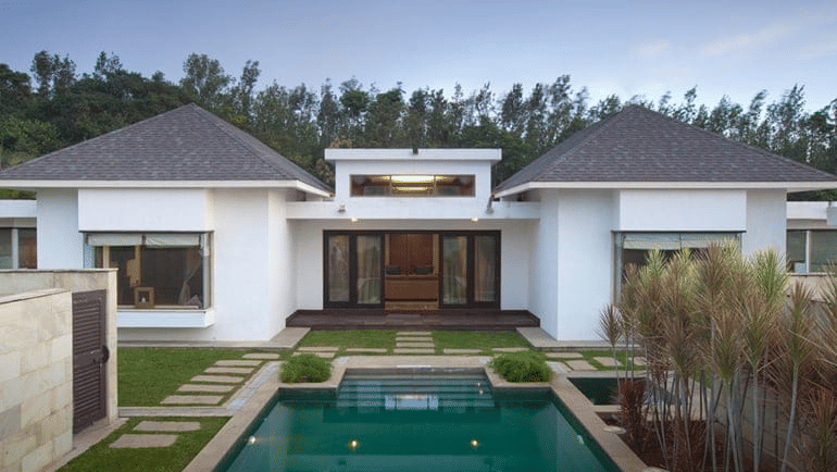 private pool at The Residence with small plants growing on one side and stone pathway on the other at The Serai, Chikmagalur - The Best Place to Stay in Chikmagalur for Couples.