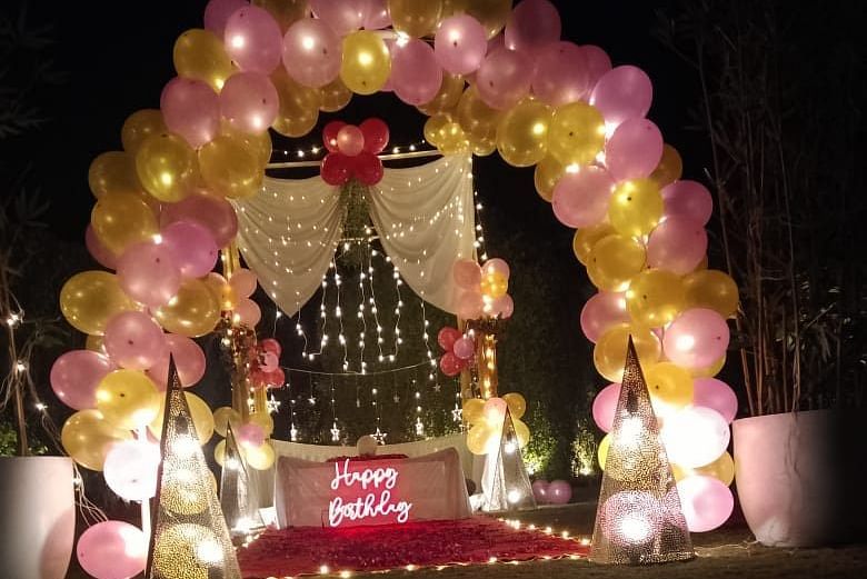 alt-text Outdoor decoration with balloons and poster at themis  mudhouse