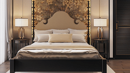 Front view of a well-made bed with cushions, a ceiling fan, and two bedside tables with lamps at The Evren, Vagator.